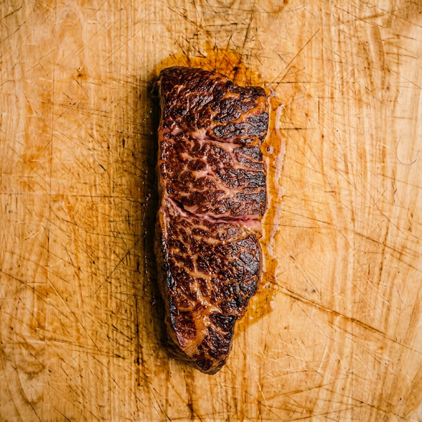 Denver steak on cutting board cooked